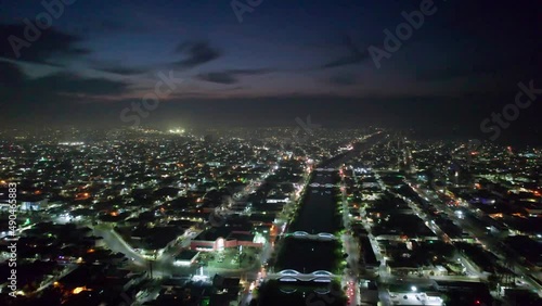 Aerial - Beautiful night over Reynosa and its river, Tamaulipas, Mexico, forward photo