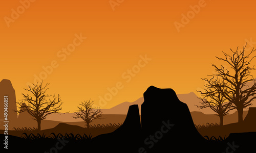 Realistic view of mountains and cliffs from outside the city at sunrise with silhouettes of dry trees around