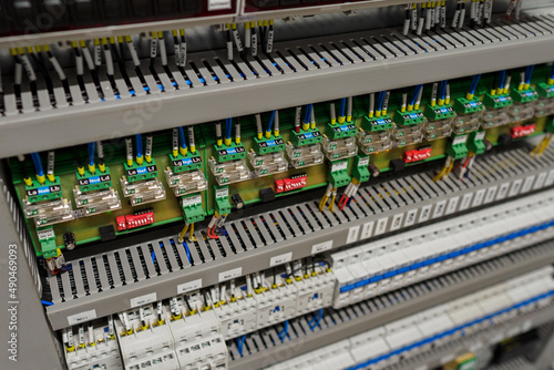 Terminal blocks and instrument fuses with connected wires in the switchboard. 