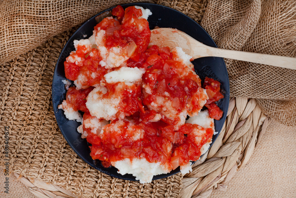 Traditional South African Pap and sous, maize meal covered in tomato and onion relish Stock ...