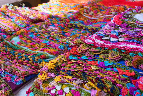 Stack of colorful crochet lace products in woman producer outdoor bazaar in Odemis, Izmir. Many or lots of different beautiful modern style needlework or handmade crochet laces. 