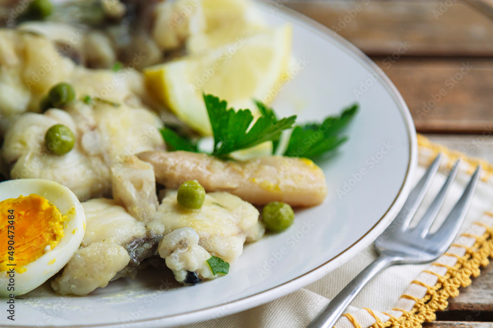 fish in sauce with egg, peas and parsley fish in sauce with egg, peas and parsley