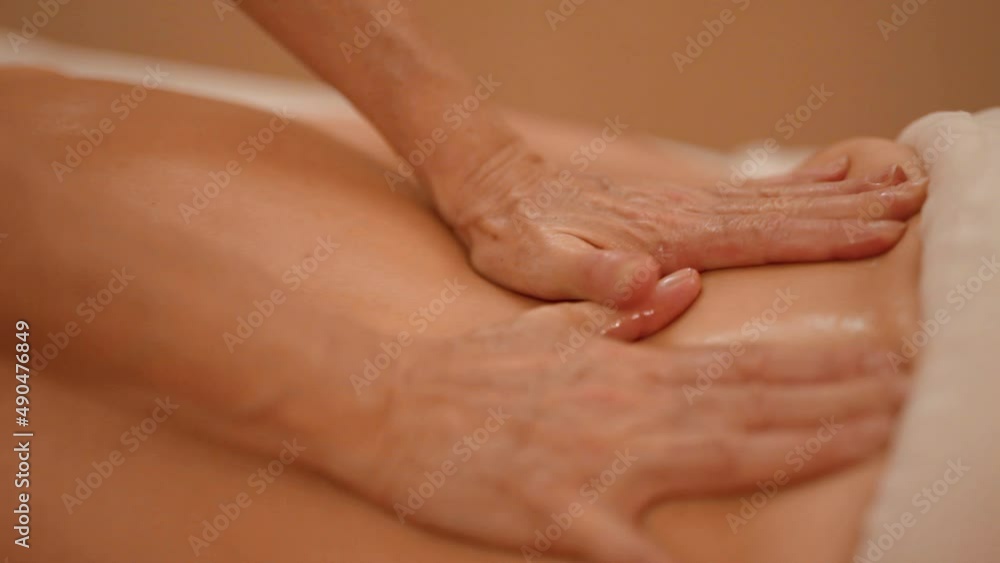 Fondling massage using oil on a shaven back Fondling massage using oil on a shaven back