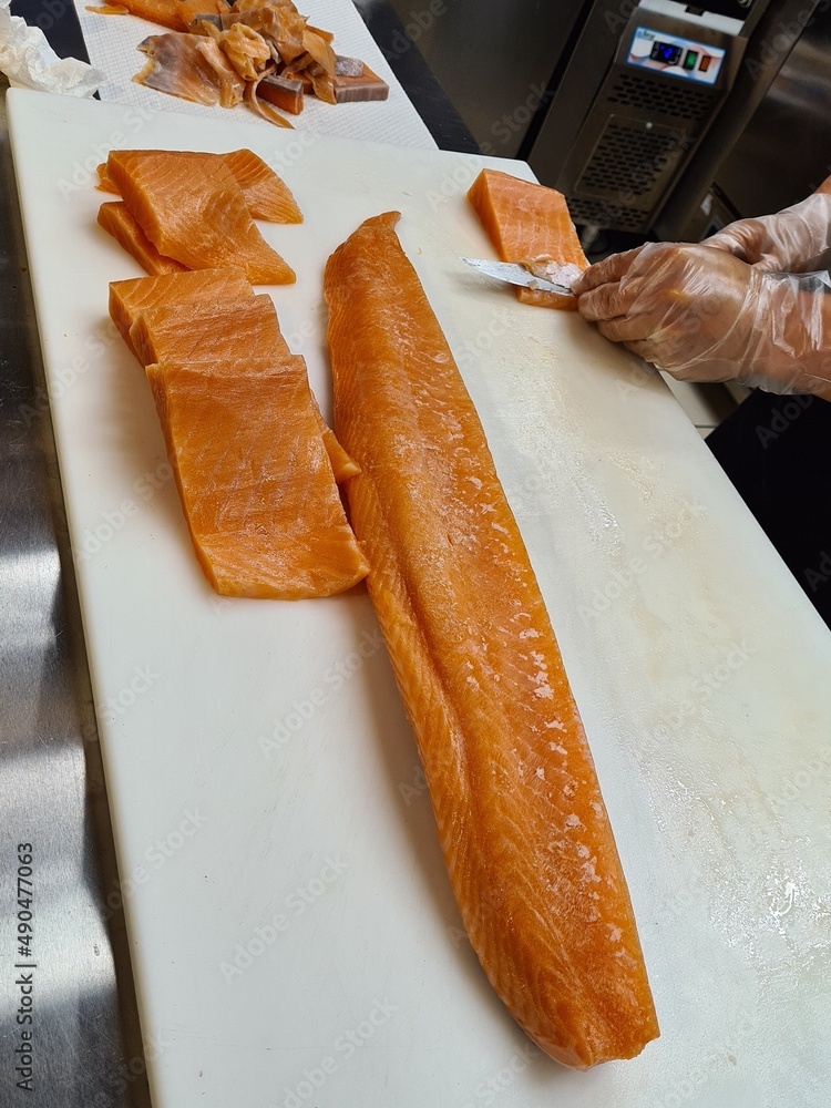 sushi chef filleting salmon