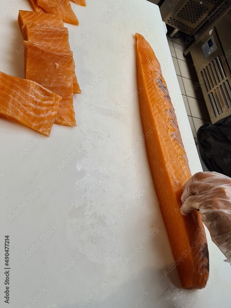 sushi chef filleting salmon