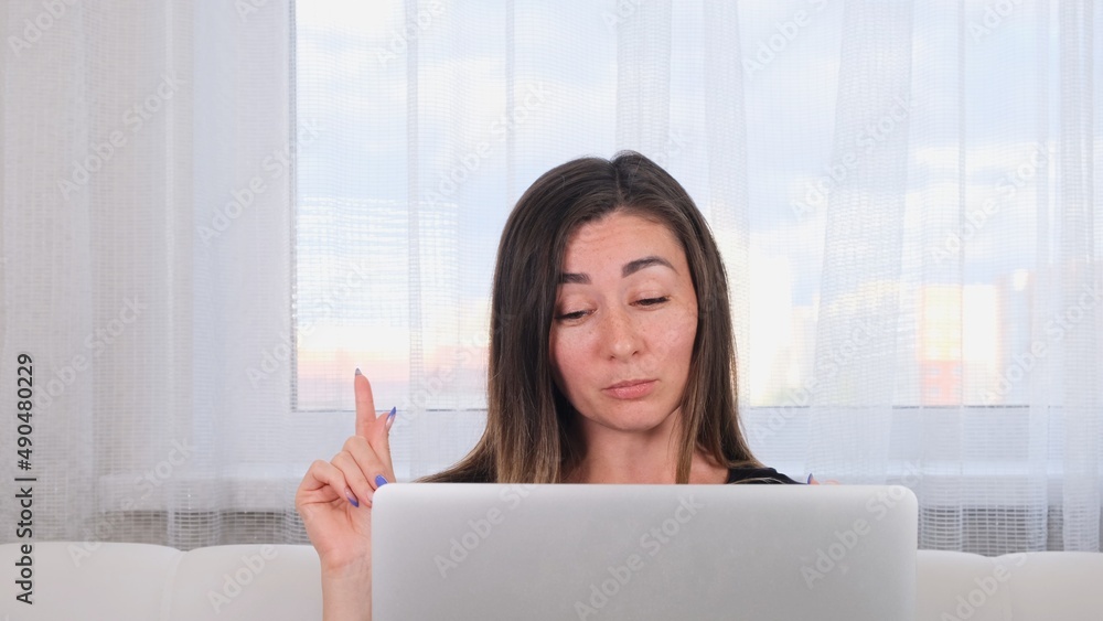 brunette girl blogger talking with friends on social networks on laptop using wireless internet. Positive young woman shopping online on the website brunette girl blogger talking with friends on social networks on laptop using wireless internet. Positive young woman shopping online on the website