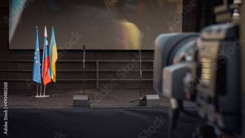 Anti war protest stage between ukraine and russia in slovenia, View from behind the camera towards stage with flags and screen