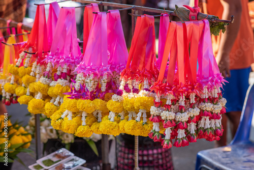 Selling flower garlands for worship in the fresh market.