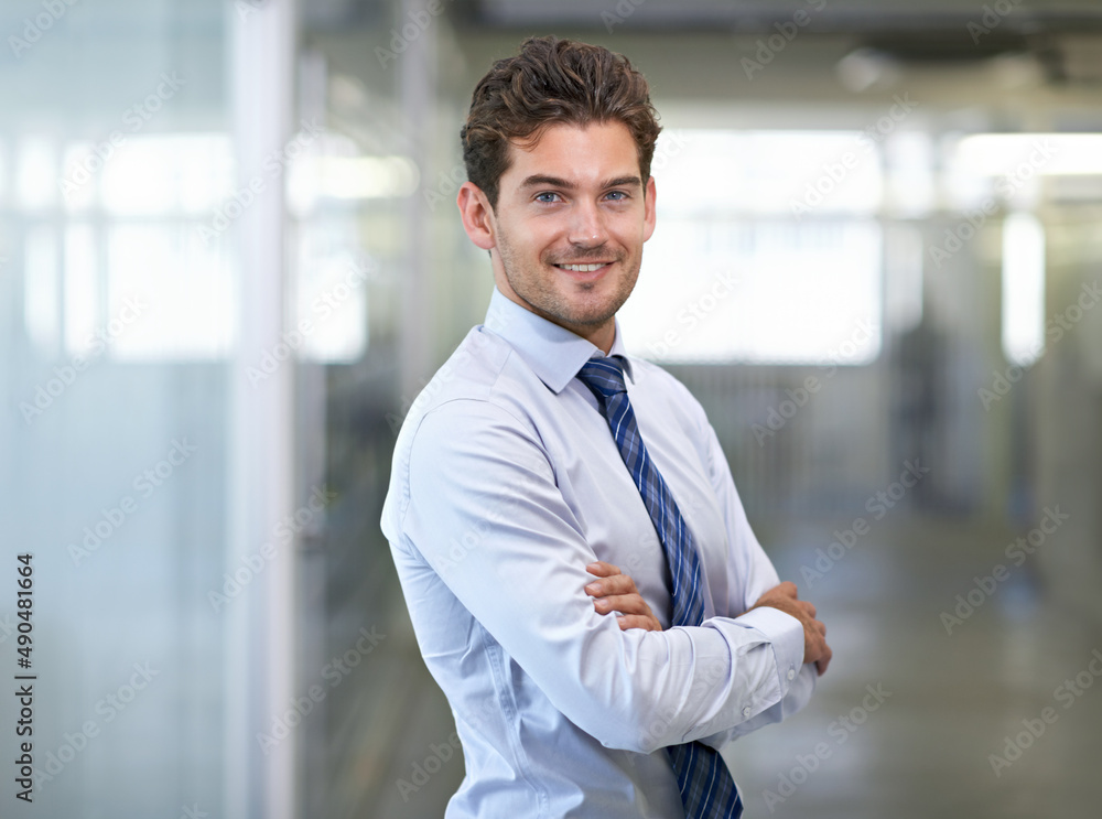 Hes a mover and shaker. Shot of a young businessman in a corporate office. Hes a mover and shaker. Shot of a young businessman in a corporate office.