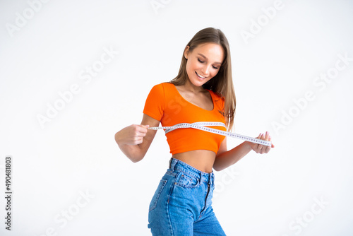 Young woman measuring her breast, checking her breast, isolated on white background