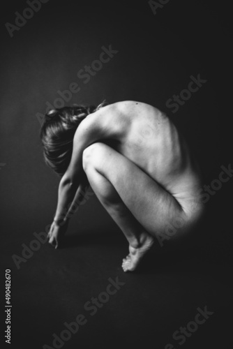 Body details close-up, nude female body. Nude skin photography in black and white. Light defocus and art noise on the frames