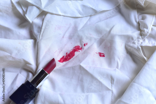 Stains of lipstick or makeup on white clothes or stains on clothes from everyday accidents. Concept of cleaning stains on clothes or cleaning the house. Selected focus