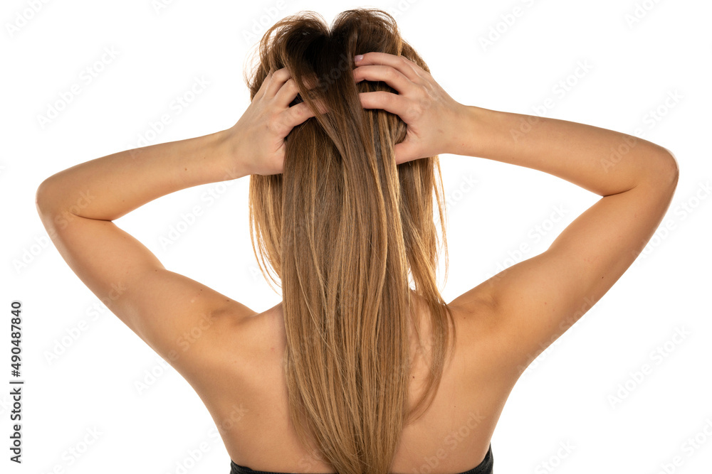 Rear view of a young woman scratching her head