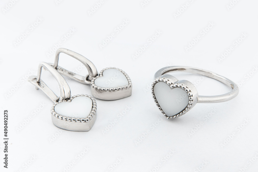 Silver jewels collection with crystals in minimalism style. Silver set of earrings and silver necklace Silver jewels collection with crystals in minimalism style. Silver set of earrings and silver necklace