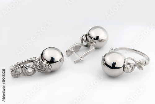 Silver jewelry set of ring and silver earrings with stones on white background. Silver jewelry set collection photo