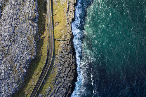 Konstfotografi Top down view on a small road by a rough stone coastline