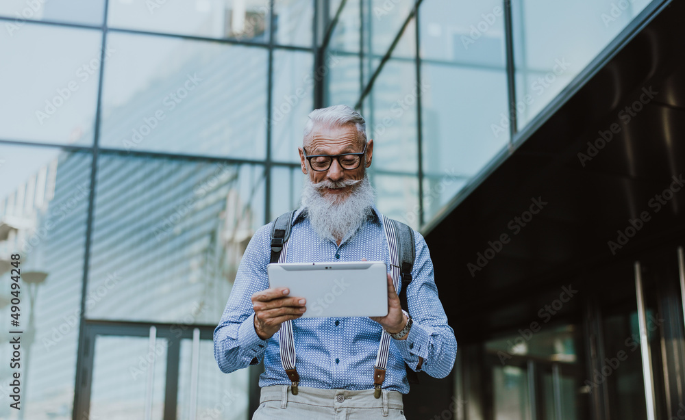 Cool Senior hipster man with stylish beard. Modern business man urban portraits outdoor. Conceptual representation of aging as a state of mind Cool Senior hipster man with stylish beard. Modern business man urban portraits outdoor. Conceptual representation of aging as a state of mind