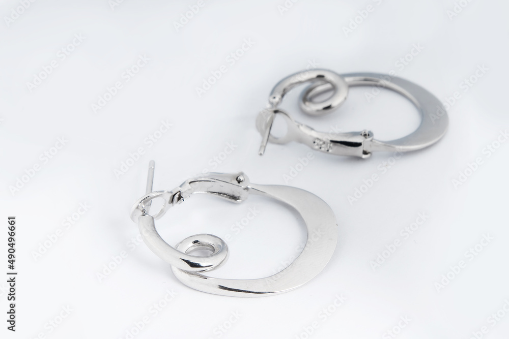Luxury silver round earrings big jewelry for women isolated on white background, clipping path included Luxury silver round earrings big jewelry for women isolated on white background, clipping path included