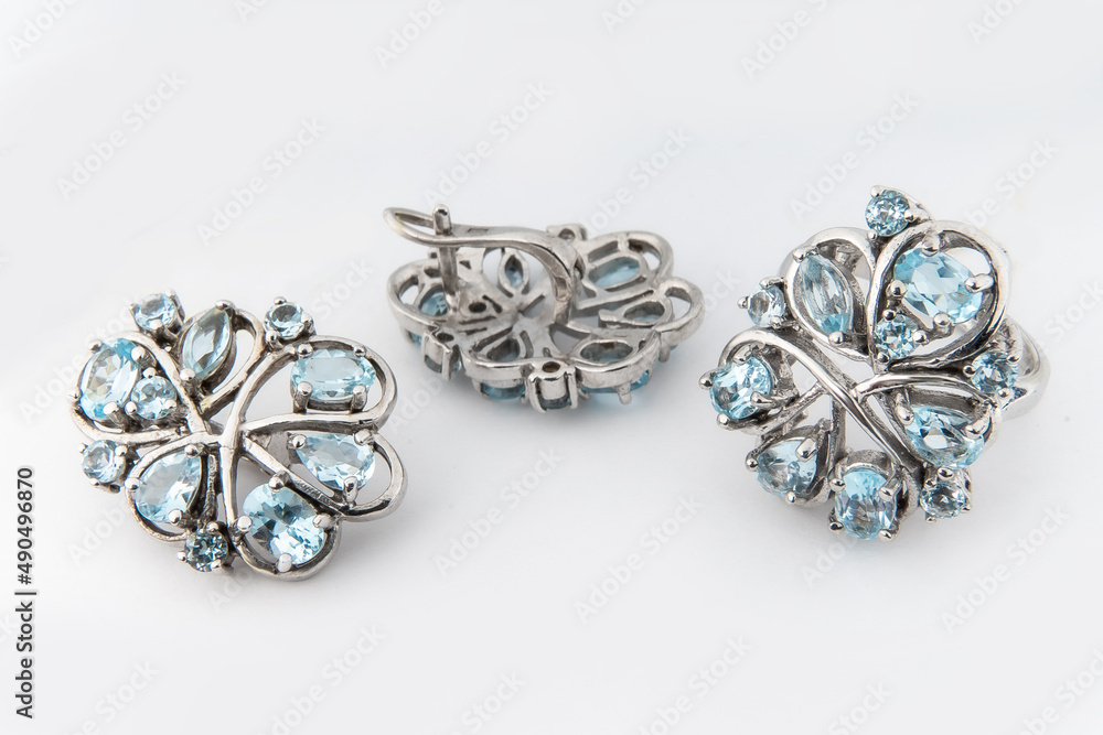 Elegant jewelry set of white gold ring, necklace and earrings with diamonds. Silver jewellery set with gemstones. Product still life concept Elegant jewelry set of white gold ring, necklace and earrings with diamonds. Silver jewellery set with gemstones. Product still life concept