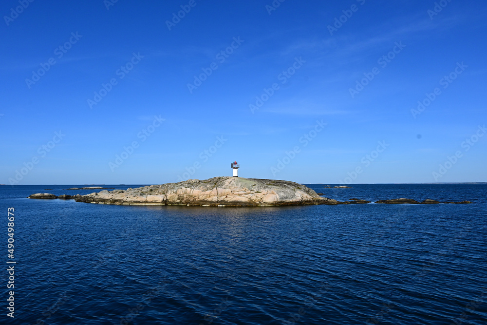Small lighthouse on a Scandinavian rock archipelago in Sweden