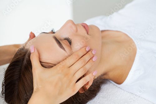 Beautiful girl has a facial massage in a beauty clinic.