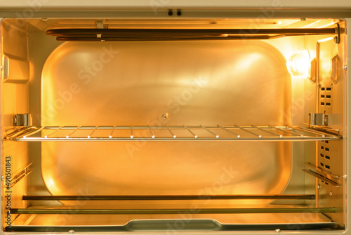 Empty Electric oven view inside with light on. Microwave © borislav15