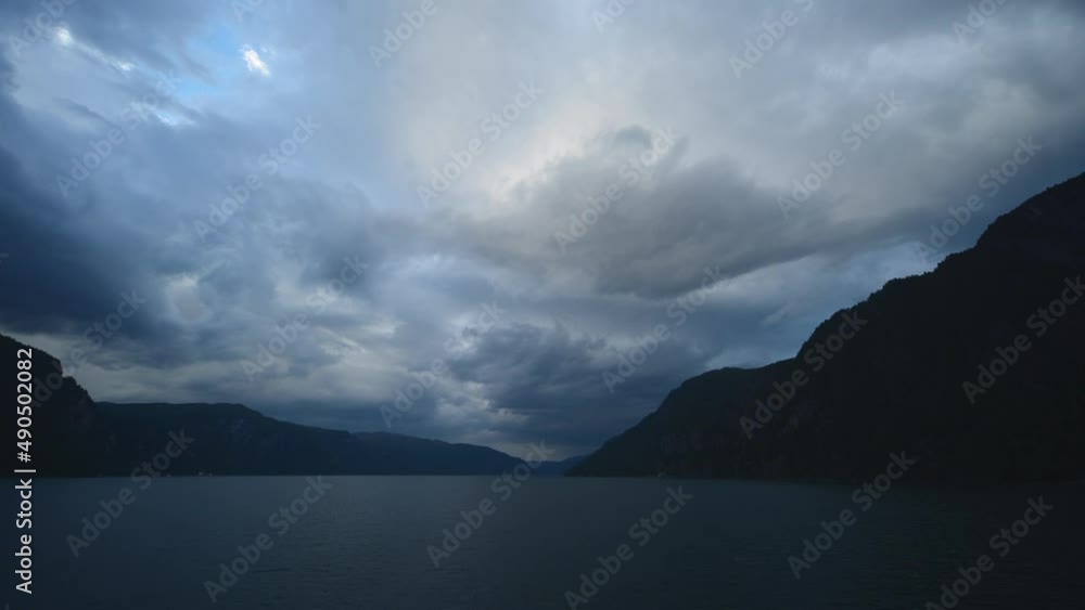 The camera is placed in the front of a cruise ship, that is sailing in the fjords of Norway. This an amazing, cinematic and unique time-lapse footage where massive, dark clouds are building up. The camera is placed in the front of a cruise ship, that is sailing in the fjords of Norway. This an amazing, cinematic and unique time-lapse footage where massive, dark clouds are building up.