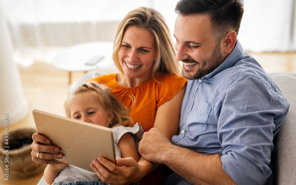 Happy family spending time at home with digital devices together. Technology people fun concept. Happy family spending time at home with digital devices together. Technology people fun concept.