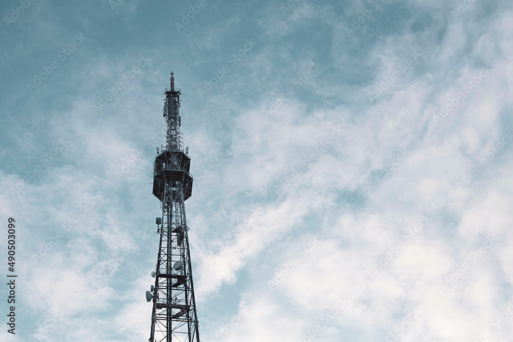 a television cell tower on the border of two states against a blue sky, the front and back backgrounds are blurred with a bokeh effect a television cell tower on the border of two states against a blue sky, the front and back backgrounds are blurred with a bokeh effect
