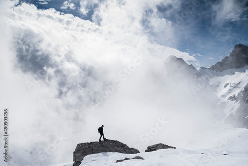 Person standing on the edge of a rock