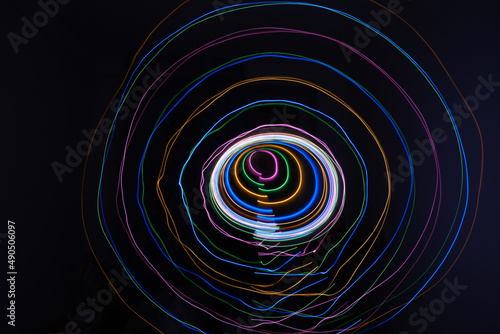 lights circles with different colour  isolated on black background. Long exposure light painting photo of abstract round form. Swirl trail effect. Picture for creative wallpaper  design art work