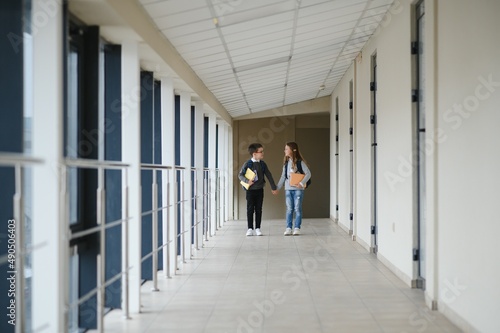 Happy school kids in corridor at school