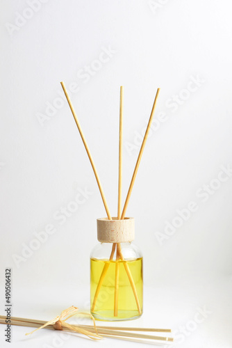 Close up, air freshener with thin wooden sticks on white background.