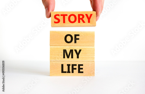 Story of my life and storytelling symbol. Concept words Story of my life on wooden blocks. Businessman hand. Beautiful white table white background. Story of my life business concept. Copy space.