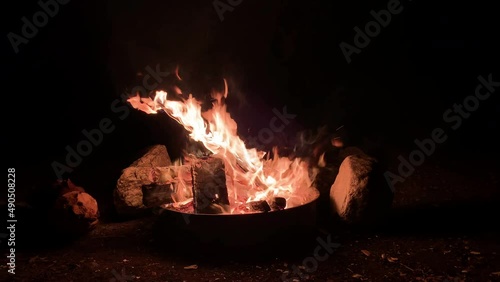 Close-up, flames from fire. Night bonfire in Azusa, California, logs are on fire, sparks fly. 4k.Burning Campfire Isolated on Black Background. Flaming Bonfire in Night Forest. Static Shot. photo