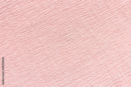 Soft pink fabric with puckered texture. Abstract background. Fashion and clothes design trends concept