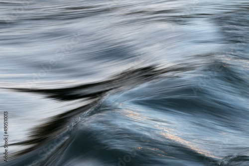 Silky abstract texture of water surface on rapid stream water flow