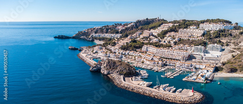 Aerial perspective of La Herradura city,Granada, Spain. Beautiful coastal city situated in south of Spain. View of the port and luxury urbanisation on hills. Mountains in background. Luxury real estat photo