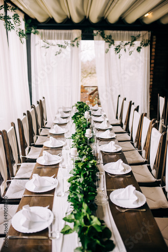 Table setting at a luxury wedding and beautiful flowers on the table. © Tobica