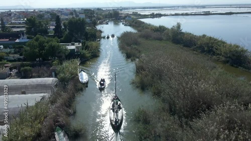 Aerial drone footage of boats with tourists on it to visit the natural park of the Albufera in Valencia, Spain. Beauty of the natural park. photo