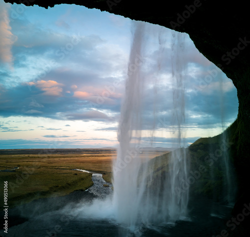 Inside Seljalandsfoss waterfall early in the morning in Iceland