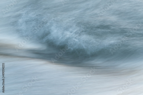 Silky water surface detail from rapid mountain stream in long exposure - abstract landscape