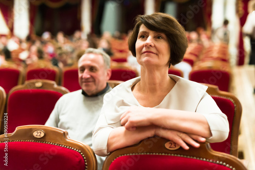 mature man and woman in theater watching a performance
