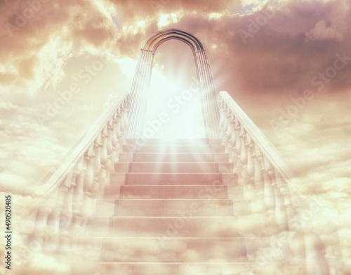Theres a light at the end of the stairway. Shot of a stairway and door leading to Heaven. photo