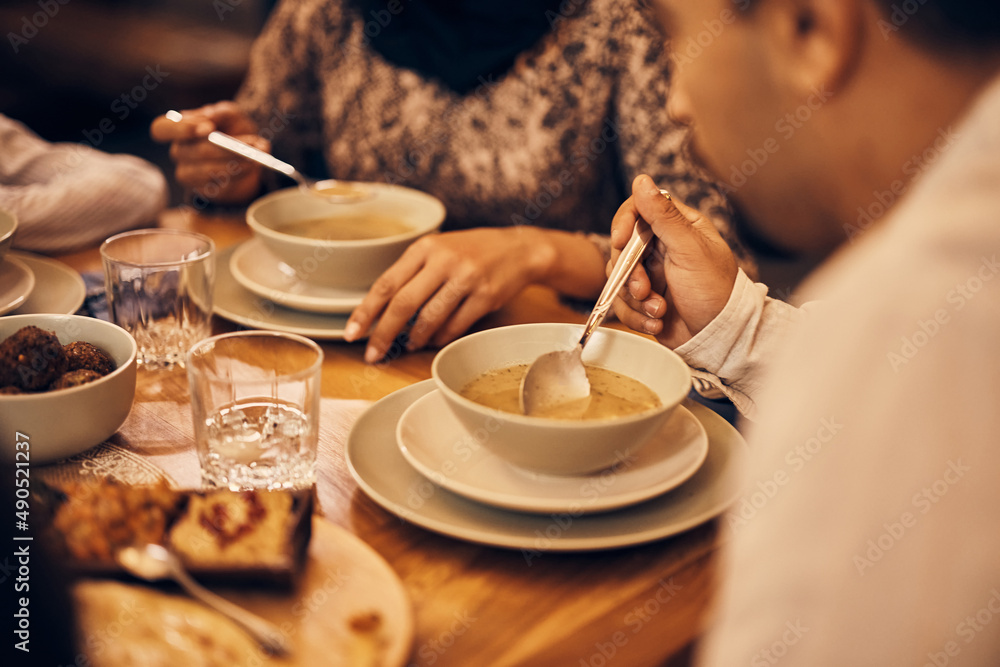 Close-up of Muslim family eats dinner at home during Ramadan. Close-up of Muslim family eats dinner at home during Ramadan.
