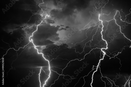 Thunder, lightnings and rain during summer storm in black and white.