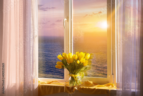 Vase with yellow tulip flow...