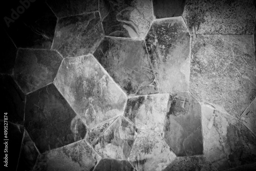 Natural slate stone mosiac puzzle facade wall.Exterior dark grey surface decorative or protect house.seamless brick texture.Achitect retro style material.Vintage slate stone masonry tile. photo