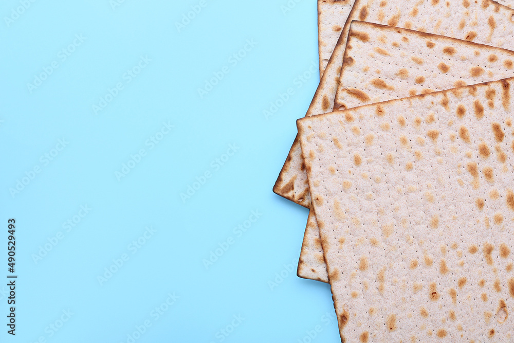 Jewish flatbread matza for Passover on blue background, closeup Stock
