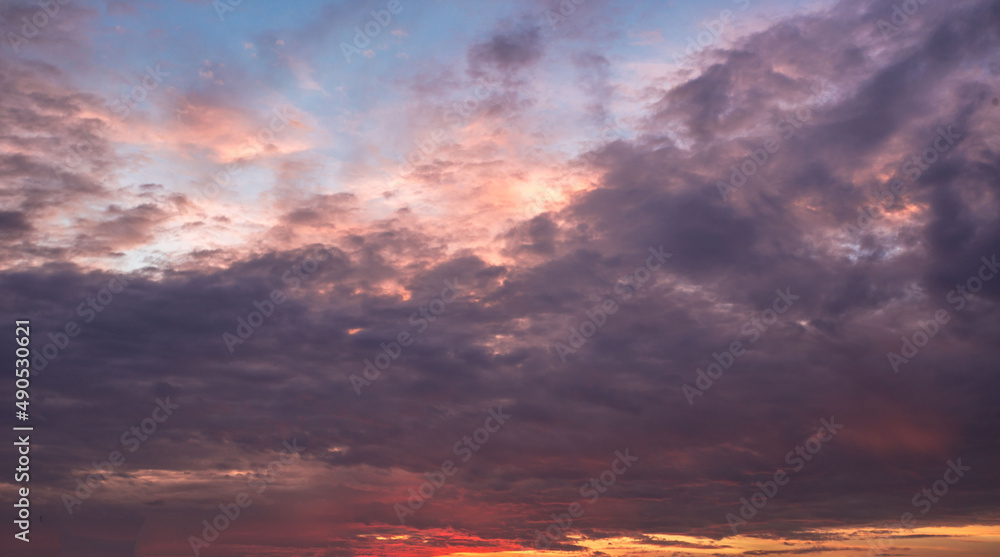 The vast Beautiful sky with orange and purple clouds that are beautiful sky before sunset. The natural sky before background has a breeze on a bright day in the summer.